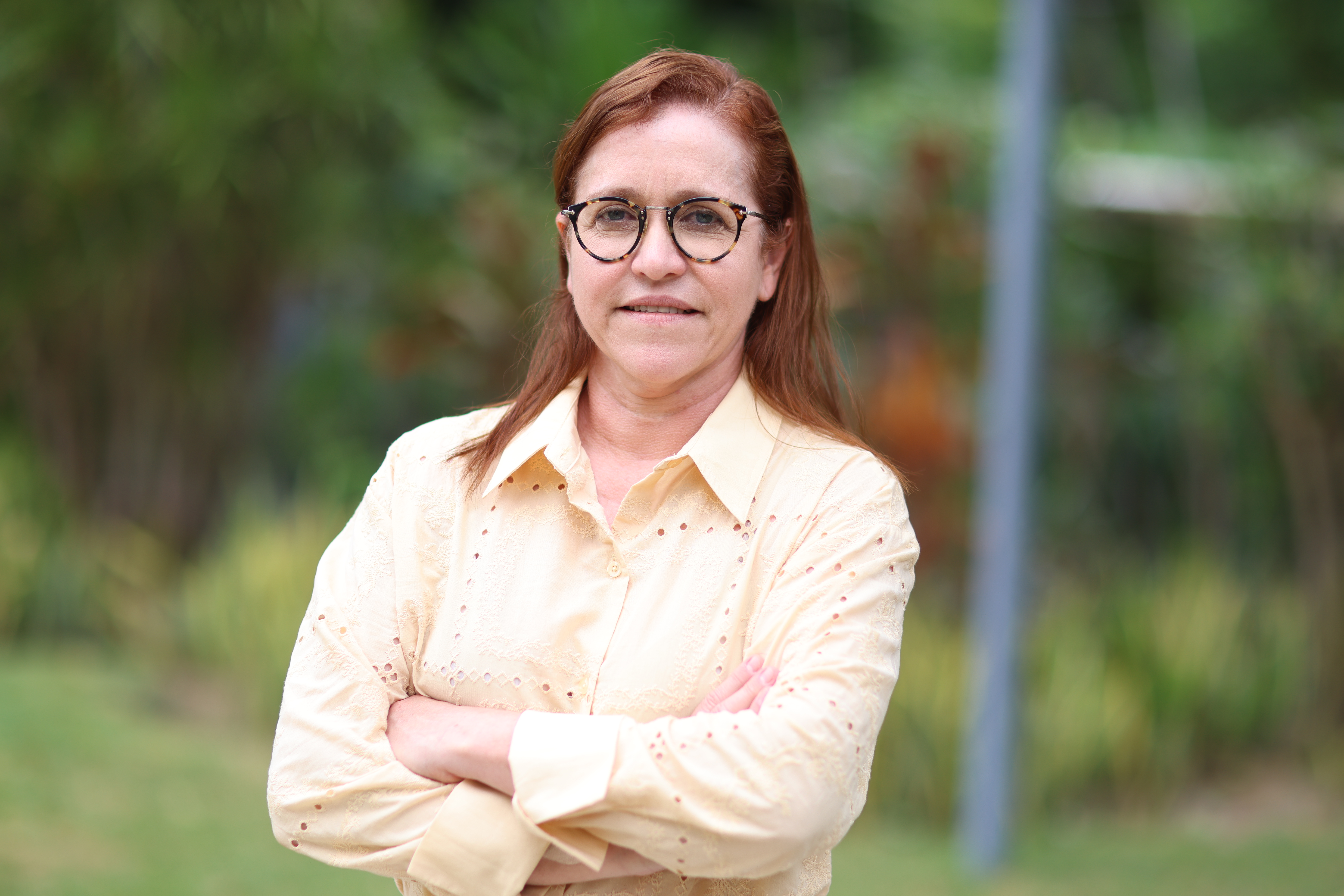 Riane Azevedo posa para a foto, ela está de blusa bege claro